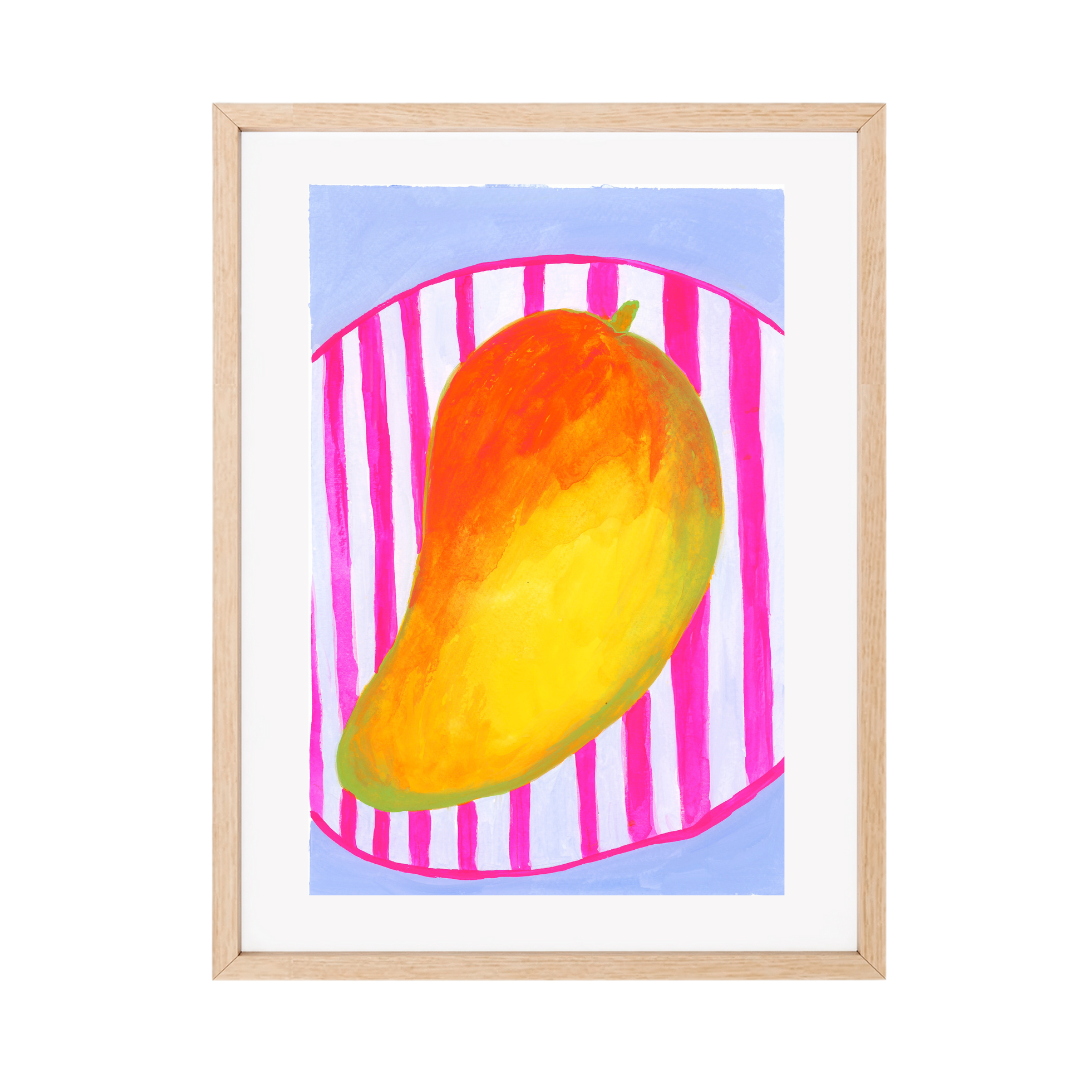 A framed original gouache artwork featuring a colourful painted mango on a pink and white striped background with a light blue sky, set in a light wood frame.