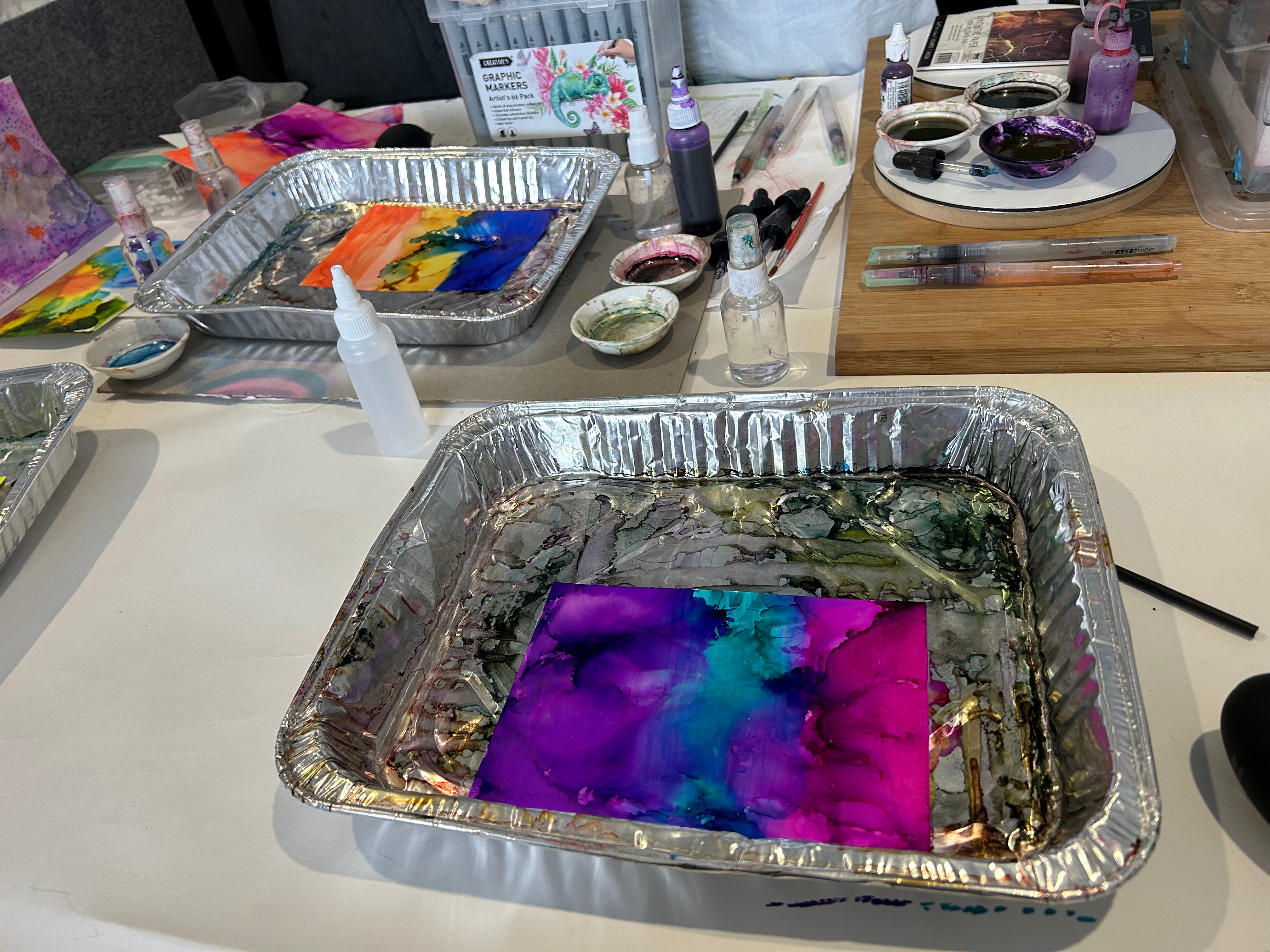 Alcohol ink painting workshop exploring colour flow, movement and abstract designs in a guided, relaxed setting.